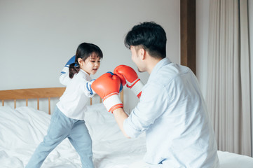 Dad and daughter playing in bed Boxing