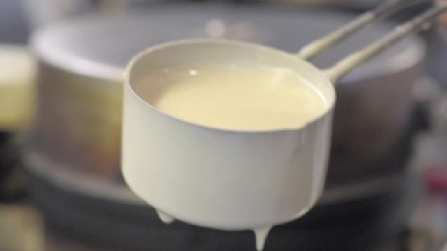 Waffle making close up footage.
The waffle mix pouring on the preheated waffle iron. Slow motion.