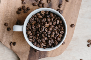Cup full of coffee beans (top view)