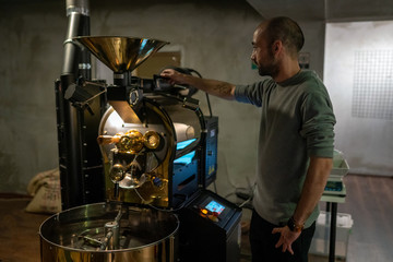 A man doing a coffee roasting operation