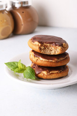  Honey cookies with peanut butter and coated with chocolate, close up, vertical