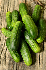 Cucumbers on a wooden table. The texture of vegetables.