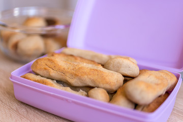 Healthy homemade sweets from rice, banana and honey in a purple food box. Selected focus.