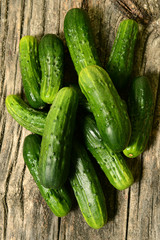 Cucumbers on a wooden table. The texture of vegetables.