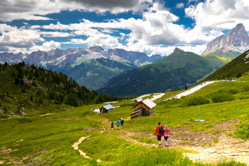 Fototapeta na wymiar Backpackers hiking. Tourists on the trial in Italian Dolomites. South Tyrol. Italy. Europe.
