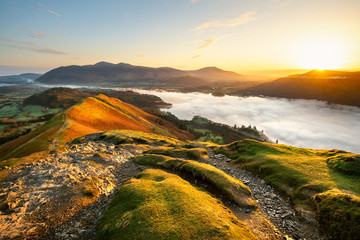 Beautiful Sunrise Overlooking Derwentwater From Catbells On A Sunny Calm Morning With Cloud Inversion Mist Over Lake. Lake District National Park, UK. - obrazy, fototapety, plakaty