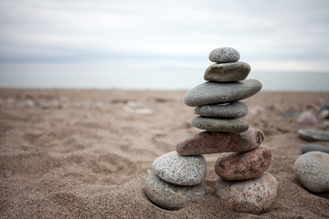 Fototapeta na wymiar A stone inukshuk on a beach.