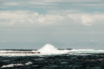 Blue ocean with waves and rocks in Australia