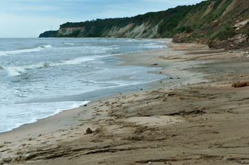 Steep coast of the sea. Landslides and destruction to the shores of the sea.