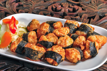 Crispy Seaweed Stuffed Shrimp in white plate on the wooden table.