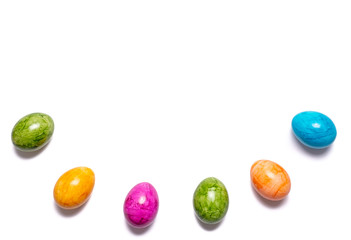 Border of easter eggs in different colors as half circle on white background