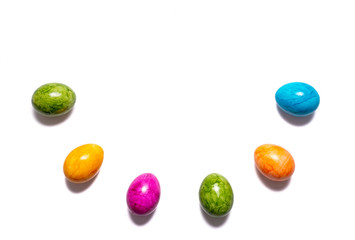 Border of easter eggs in different colors as half circle on white background