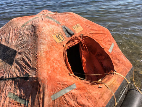 a smal life raft floating on the sea.
