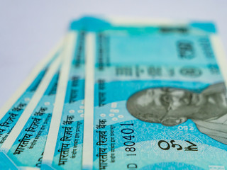 Close up of fifty rupee money notes with Gandhi figure defocused.