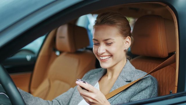 Closeup smiling woman sitting in new car. Happy woman getting keys from new car