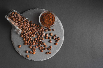 Spilled cup of coffee beans on a round slate