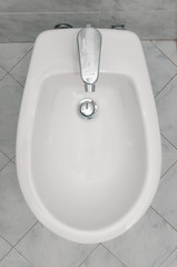 White ceramic bidet in italian bathroom - obrazy, fototapety, plakaty