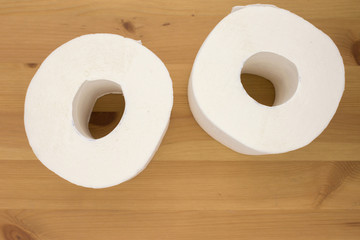 White toilet paper, rolled,  on wooden  background, copy space.