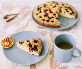 Piece of pie on plate with cup of tea on white table. Breakfast with tea and cake. Food photography. Table top photo. Tea time