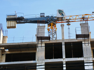 Naklejka premium Construction crane near the building under construction