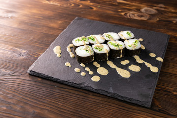 chuka rolls with sauce on black japan plate