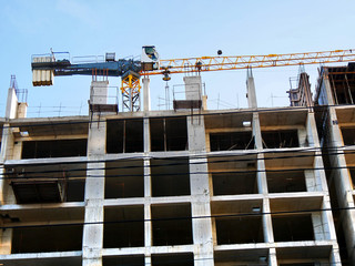 High rise construction site. Under construction. Crane near building. Industrial background.