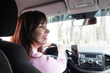 Girl behind the wheel smiles