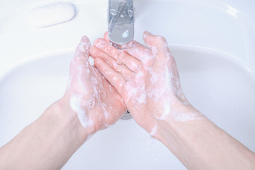 Fototapeta premium Washing hands in the sink rubbing with soap man for corona virus ,COVID-19 prevention, hygiene to stop spreading coronavirus.Destruction of the virus