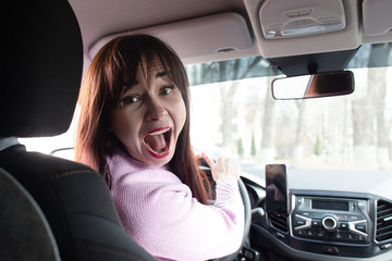 Brunette girl screams in car