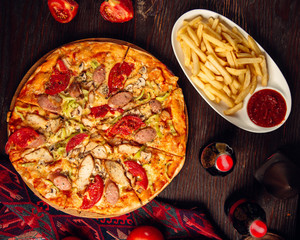 mixed pizza with sausages and fries