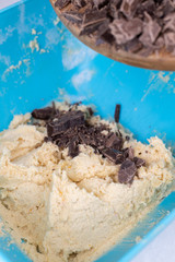 Cookie flour mixture in the bowl with black cooking chocolate