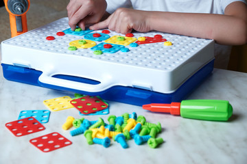 child collects a constructor puzzle