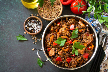 Indian food, authentic indian dish. Traditional Indian spicy green lentils with meat, spices, herbs on a stone table.