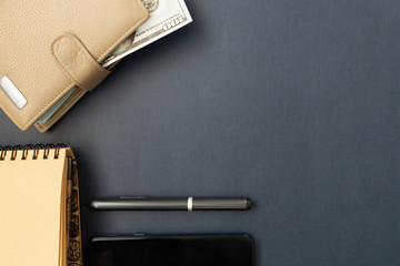 business layout, purse and notepad on a black background
