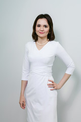 Smiling medical doctor woman isolated over white background.