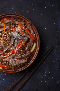 Wok pork in pad thai sauce with funcho noodles