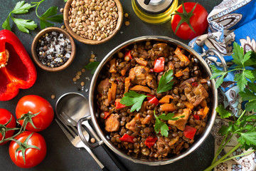 Indian food, authentic indian dish. Traditional Indian spicy green lentils with meat, spices, herbs on a stone table. Top view flat lay background.