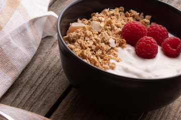  delicious breakfast with yogurt, granola and raspberries