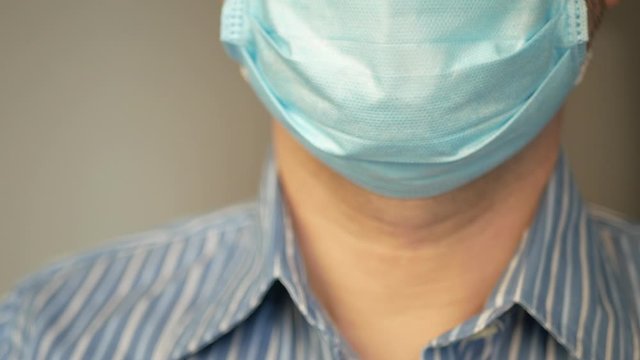 a sad man with virus, covid-19 and mask on his face for antivirus protection taking deep breath, rapid breathing