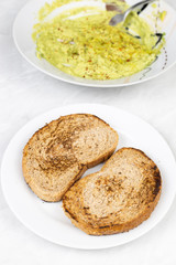 Avocado spread with grated pepper and toasted sliced of bread