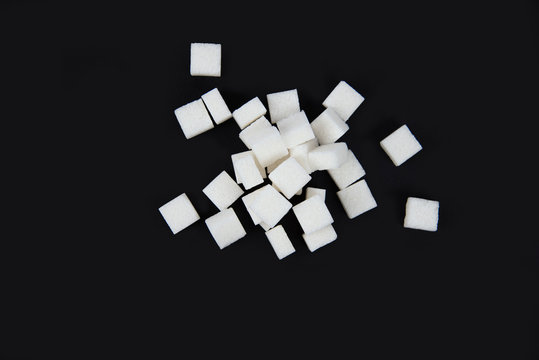 White Sugar Cubes Isolated On Black Background