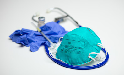 Surgical Mask, Syringe and Gloves on Stethoscope