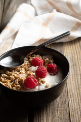  delicious breakfast with yogurt, granola and raspberries