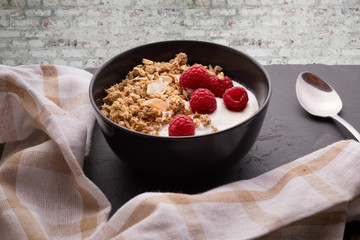  delicious breakfast with yogurt, granola and raspberries