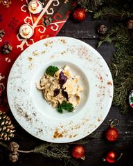 pasta with cheese and mushrooms topped with basil