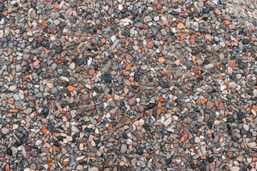 Gravel texture for your design. Crushed multicolored rubble and stones, granite chips in road surface closeup
