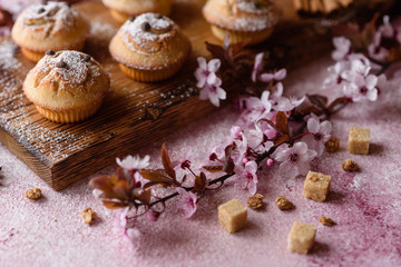 Fresh baked cupcakes of rice flour with banana and vanilla with a mug of hot chocolate