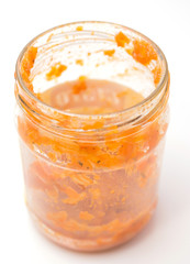 Russian food, a jar with stewed cabbage a type of broth on a white