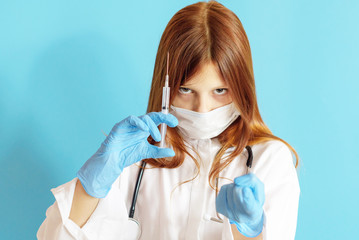 A teen girl plays doctor, a concept of choosing a profession for a child, a red hair girl in a white shirt, wearing a protective face mask and with a phonendoscope in her hands