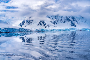 Fototapeta na wymiar Snow Mountains Blue Glaciers Refection Dorian Bay Antarctica